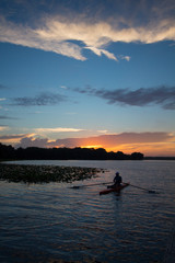 Naklejka na ściany i meble Daybreak at a central Florida lake with a kayaker rowing.