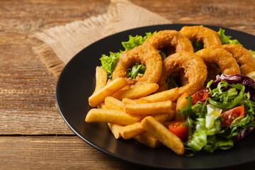Roasted squid rings with fries.