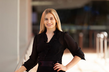 business person smiling outside office building