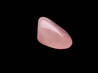 Raw rose quartz isolated on black background. Macro shot.