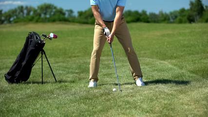Rich man playing golf on course, performing draw position, training and hobby