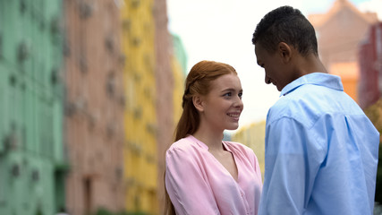 Fototapeta premium Beautiful couple of teenagers looking at each other, feeling true love, romance