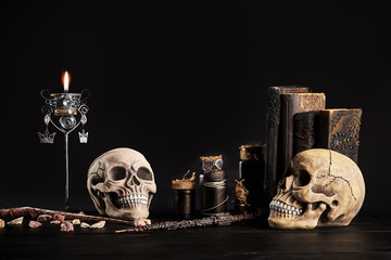 Realistic model of a human skull with teeth on a wooden dark table, black background. Medical...