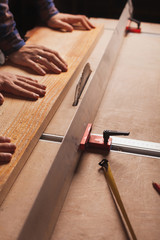 Carpentry workshop background with male hands and tools