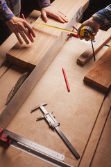 Carpentry workshop background with male hands and tools