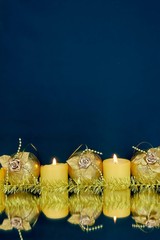 Golden Christmas balls and candles on a dark blue background