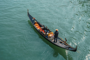 Fototapeta na wymiar Tourists in gondolas on canal of Venice.