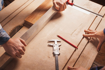 Carpentry workshop background with male hands and tools