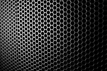 Satin and black metal grid macro protecting an amplifier as a wallpaper