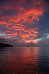 The red sunset over Mae Haad Beach, Koh Phangan, Thailand
