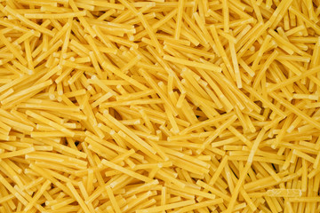 small pasta texture background closeup. vermicelli.  raw small noodles