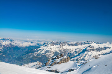 Fototapeta na wymiar View from Mt. Titlis in the Swiss Alps. Titlis (also Mount Titlis) is a mountain of the Uri Alps, located on the border between the Swiss cantons of Obwalden and Bern.