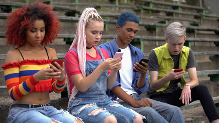 Fototapeta na wymiar Addicted teenagers scrolling smartphones, online connection cyber generation
