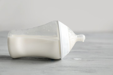 Bottle of baby milk formula on table
