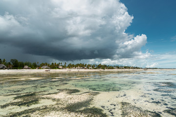 Dark clouds over exotic beach