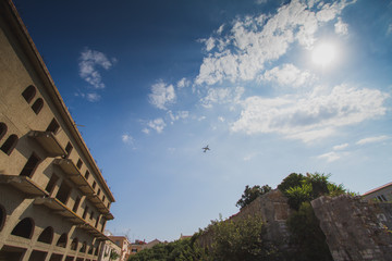 The plane is taking off from an old european town