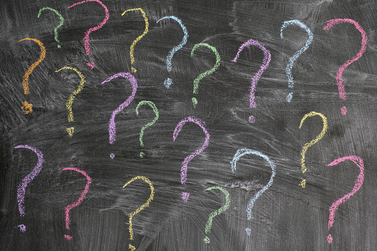 Colorful question marks on a blackboard