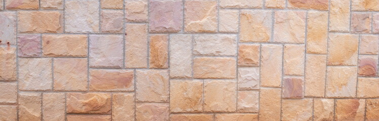 Abstract panorama image of Orange grunge stone wall texture background for exterior decoration.