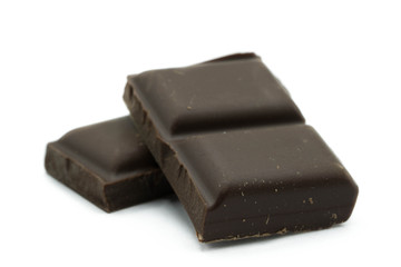 Dark chocolate pieces isolated on white background