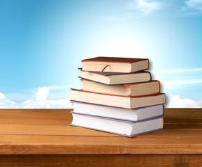 Colorful books collection on classroom background