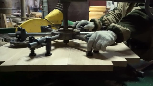 Making a wooden lid for a wine barrel on a modern woodworking machine in a cooper