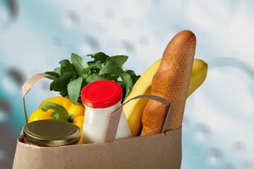 Full shopping bag on supermarket background