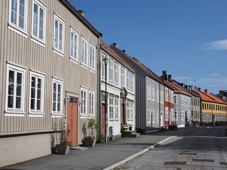 Scenery of narrow street with old colorful wooden buildings in european Trondheim city in Norway