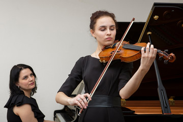 Musicians of the symphony orchestra. Young violinist and pianist in concert dresses. © biggur