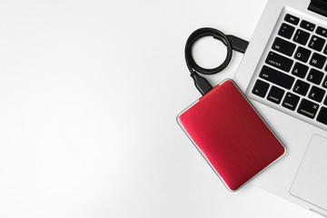 External Hard disk connect to laptop, External Hard disk and laptop computer, White background, Top view workspace