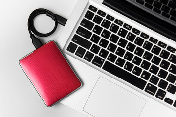 External Hard disk connect to laptop, External hard disk and laptop computer, White background, Top view workspace