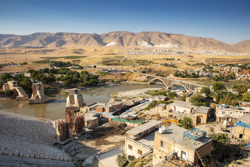Panoramic view of the Old Tigris Bridge, Castle and minaret in the city of Hasankeyf, Turkey....