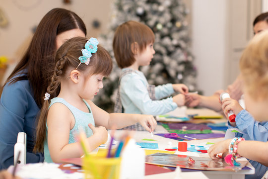 Group of kids doing postcards to christmas holiday cutting paper