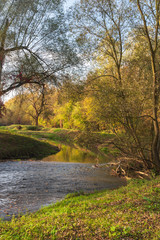 Fototapeta na wymiar Lucina river with colourful trees on the background near Slezskoostravsky hrad in Ostrava city in Czech republic