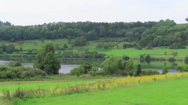 Landscape of Schalkenmehrener Maar lake with volcano caldera.