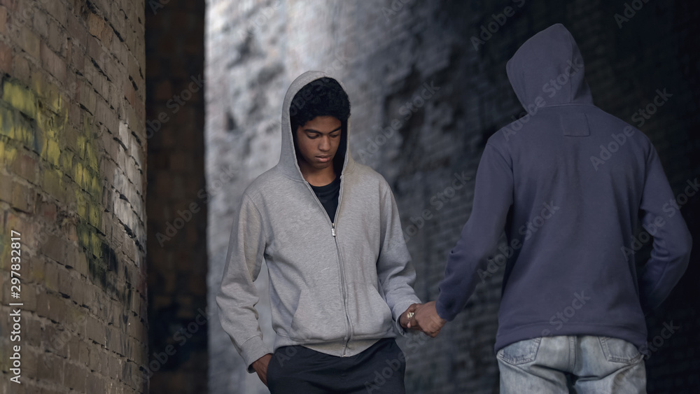 Wall mural young black men exchanging money to drugs in abandoned building, addiction