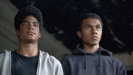 Afro-american teenagers looking forward, going to commit crime, urban danger