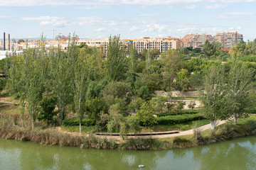 Fototapeta na wymiar Beautiful green urban park. Public park with green grass fields, trees, waterways and pond. Parque de Cabecera, Valencia, Spain