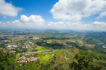 Panaramic areal view to hills, roads, green woods and houses from mountain Monte Titano, San-Marino