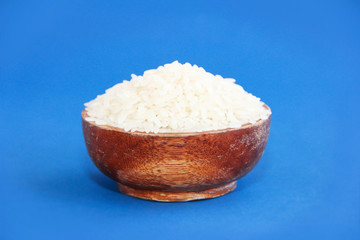 white natural fresh rice in a brown wooden plate