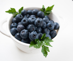 blueberries in a bowl isolated on white background