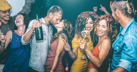 Happy friends having multiracial fun at new year's eve celebration - Young people drinking and...