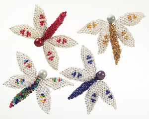 A pic of four colourful beaded dragon flies Christmas tree decorations
