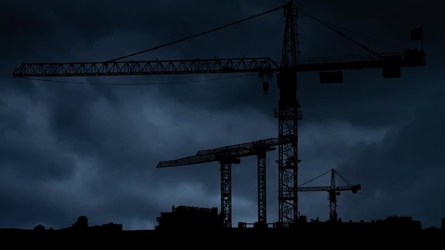 Construction Site with Big Tower Crane in Silhouette, Thunderstorm and Lightning Time Lapse , Under Construstion Concept