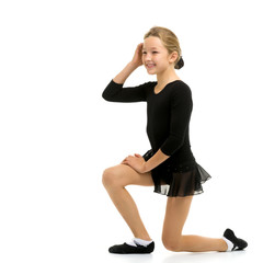 Cute little girl gymnast getting ready to perform a difficult ex