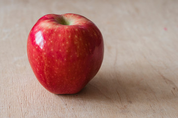 Red apple on old wooden table