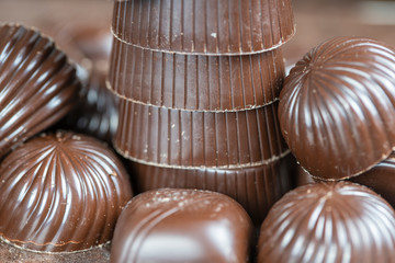 Brown chocolate candy background. Assortment of chocolate candies sweets