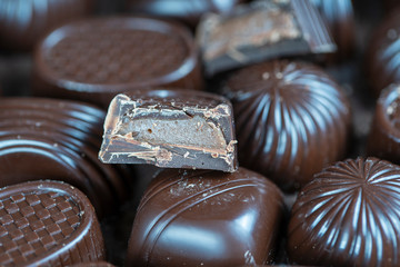 Brown chocolate candy background. Assortment of chocolate candies sweets