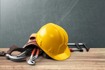 Tool belt with tools on wooden background