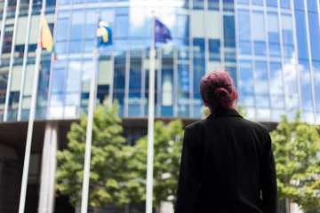 Fototapeta premium Back view of a female manager walking to her new work place