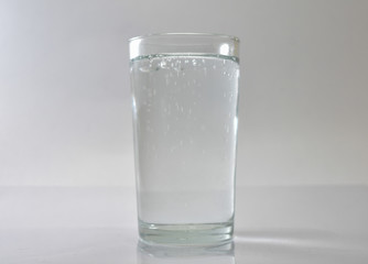 Transparent glass and bubbles on a white background